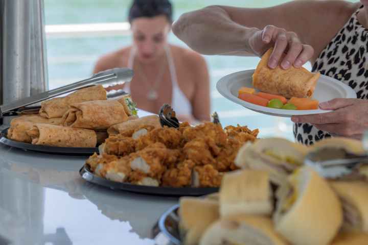 a woman sitting at a table with a plate of food